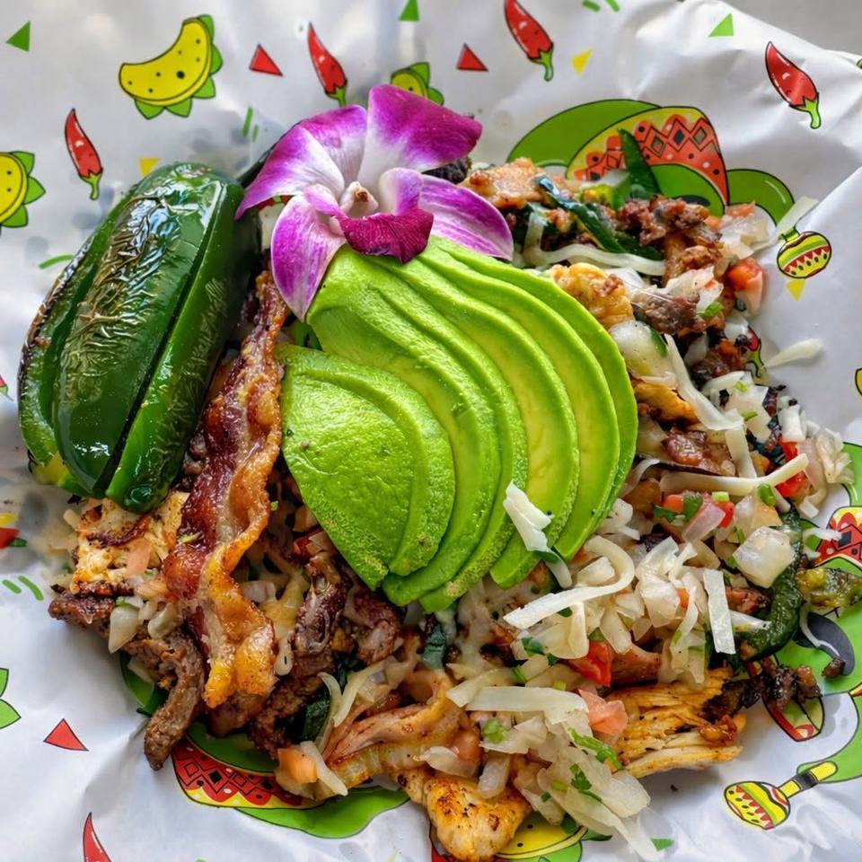 Grilled steak, chicken and bacon with sliced avocado, melted cheese, pico de gallo and a roasted jalapeño